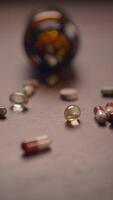 Scattered Capsules and Various Different Types of Pills Found on a Wooden Surface Background Space video
