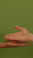 Hands Reaching Out Toward the Viewer Against a Bright Green Background Symbolizing Life video