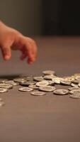 Scattered coins on a weathered table create a captivating visual composition that draws attention video