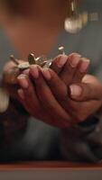 Hands Holding Coins with Falling Change, Symbolizing Financial Transactions and Wealth Growth video
