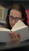 A Young Reader in a Library Who is Deeply Engaged and Focused on an Interesting Book video