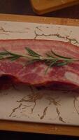 Freshly prepared Meat with fragrant Rosemary placed elegantly on a Marble Cutting Board for display video