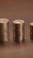 Neatly Organized Piles of Coins Placed on a Rustic Wooden Surface Under Natural Light video