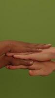 An array of diverse hand interactions beautifully set against a vibrant green background video