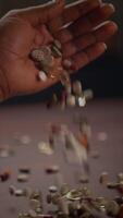 A Diverse Assortment of Colorful Pills is Carefully Held in the Hand Above a Table Surface video