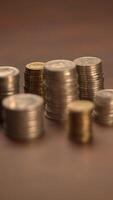 An aesthetically pleasing display of stacked coins arranged on a rustic wooden surface video