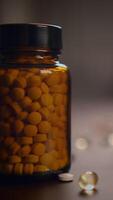 Amber Bottle That is Filled to the Top with Round Tablets and Softgel Capsules Inside video