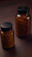 A Collection of Bottles Filled with Supplements and Pills Resting on a Rustic Wooden Surface video