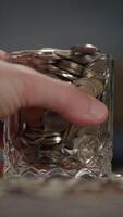 A Glass Jar That Is Filled Up Completely with Various Coins of Different Denominations video