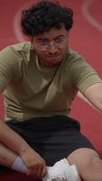 An Athlete Engaging in Focused Stretching Exercises on the Track Field for Optimal Performance video