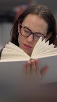 Focused reading involves a person deeply engaged in absorbing the content of a book video