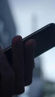 A CloseUp Image of a Hand Gripping a Smartphone While in a Busy Urban Environment video
