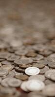 Detailed closeup of various coins neatly arranged on a flat surface for examination video