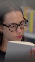 A Focused Reader in a Calm and Serene Library Setting, Surrounded by Books and Knowledge video
