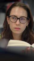 A Focused Woman Deeply Engrossed in Reading in a Contemporary and Modern Workspace Setting video