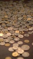 A Diverse Array of Coins Dispersed Across a Table Surface, Showcasing Their Variety and Texture video