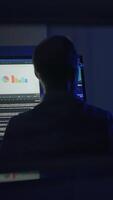 A Focused and Dedicated Professional Actively Engaged in a Media Project within a Dark Studio Space video