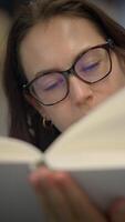 A Woman Engaged in Reading a Book with an Extremely Focused and Thoughtful Expression video