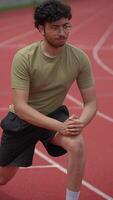 An Athlete Engaging in Stretching Exercises on the Track Before Their Running Session Begins video