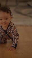 A Cute Baby Happily Crawling on a Wooden Floor in a Cozy and Inviting Home Environment video