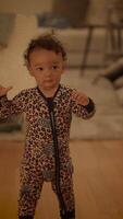 A Playful Child Dressed in Colorful Pajamas Engaging in Joyful Activities and Fun video