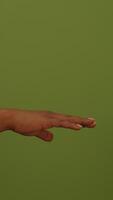 A hand gesture on a green background, inviting positive interaction and expression video