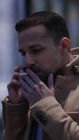 A man smokes in a vibrant urban setting at dusk, creating a captivating atmosphere video