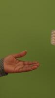 An Open Hand Gesture Set Against a Vibrant Green Background Signifying Care and Connection video