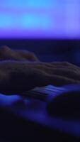 Closeup of hands playing keyboard amid vibrant lights, enhancing creativity and expression video