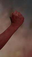 A Powerful Symbolic Empowerment Fist Gesture Set Against a Dramatic and Impactful Background video