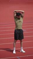 An Athlete Engaging in Stretching Exercises on the Track during an Essential Warmup Session video