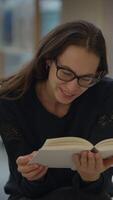 A Joyful Reader Delighting in a Book While Nestled in a Cozy and Inviting Environment video