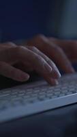 Focused hands rapidly type on a keyboard in dim light, highlighting creativity and communication video