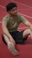 Young Athlete Doing Stretching Exercises on Track Field Before Their Training Session Commences video