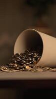 A White Cup Overflowing with Spilled Coins Symbolizing Wealth, Prosperity, and Abundance video