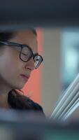Dedicated and Focused Professional Actively Analyzing Data in a Modern, Collaborative Workspace video