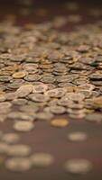 Scattered coins on a surface, representing the various aspects of currency usage and value video