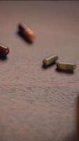 A Vibrant Array of Colorful Capsules Arranged Neatly on a Wooden Surface for Display video