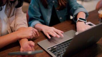 Collaborative Work. Two women partners work together on a project, their hands hovering over a laptop, demonstrating a sense of shared purpose and innovation. video