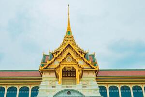 A tranquil ancient temple in a serene city, surrounded by lush greenery and bright skies, Bangkok, Thailand. photo