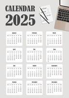 2025 calendar template with a laptop and a sheet for notes .Gray, beige and white colors. Portrait orientation. vector