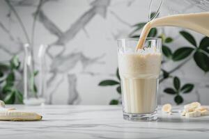 A glass of milk being poured into a glass photo