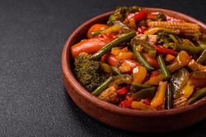 Mix of vegetables corn, carrots, peppers, broccoli, onions in teriyaki sauce photo