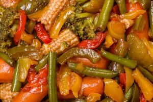 Mix of vegetables corn, carrots, peppers, broccoli, onions in teriyaki sauce photo