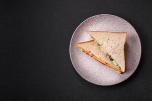 Sandwich with ham, salami, tomatoes, mustard, salt and spices photo