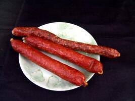 Sausage on a plate close view background photo