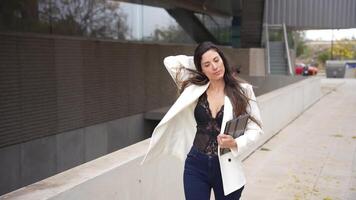 An Elegant Woman Striding Gracefully in a Stylish and Chic Outfit on the City Streets video