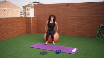 Outdoor Fitness Routine Engaging in Exercises on a Balance Ball While Surrounded by Nature video