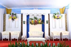 Modern Javanese Wedding Stage with Elegant White and Gold Accents photo