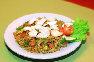 Indonesian Fried Rice with Crispy Crackers and Fresh Vegetables photo